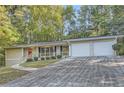 House exterior with two-car garage and driveway at 443 Creekwood Pass, Dallas, GA 30157