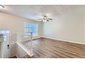 Open living room with hardwood floors and ceiling fan at 4660 Edwina Sw Ln, Atlanta, GA 30331
