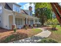 Tan house with a wrap-around porch and nicely landscaped yard at 12 Riverwood Lndg, Dallas, GA 30157