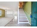 Bright entryway with staircase, wood-look flooring and green walls at 1243 Royal Ives Ct, Lawrenceville, GA 30045