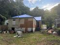 Back of house showing damage and needs significant repair at 879 Edwin Nw Pl, Atlanta, GA 30318