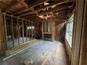 Unfinished living room with exposed beams and fireplace at 879 Edwin Nw Pl, Atlanta, GA 30318