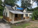 Small house with blue tarp on roof, showing some damage at 879 Edwin Nw Pl, Atlanta, GA 30318