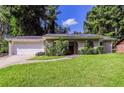 Brick ranch home with a white garage door and a landscaped yard at 2895 Springfield Ct, Atlanta, GA 30349