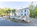 Side view of a luxurious white mansion with a brick driveway at 3915 Muirfield Sq, Duluth, GA 30096