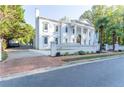 Grand white mansion with a long driveway and gated entry at 3915 Muirfield Sq, Duluth, GA 30096