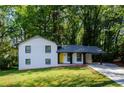 Renovated ranch home with yellow door and carport at 3900 Hilton Cts, Decatur, GA 30035