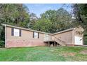 Ranch home with brick accents, deck, and two-car garage at 4111 Wrexham Dr, Snellville, GA 30039
