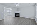 Living room with fireplace, tile floors, and ceiling fan at 308 Goldenrod Dr, Stockbridge, GA 30281