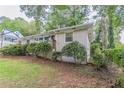 Side view of a ranch home showcasing its brick facade and yard at 2362 Manor Ave, Atlanta, GA 30344