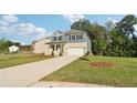 Two story home with gray siding and brick accents at 7276 Eton Ln, Locust Grove, GA 30248