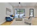 Spacious living area featuring a cozy sitting area and sliding glass doors at 5255 Buice Rd, Alpharetta, GA 30022
