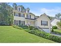 Two story house, light yellow siding, attached garage, and manicured lawn at 3141 Little Forest Ct, Snellville, GA 30078