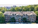 Apartment building with tree-lined backdrop and ample parking at 1910 Cedar Glenn Way # 4403, Atlanta, GA 30339