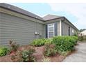 Gray house exterior with landscaping and a small walkway at 7899 Bluefin Trl, Union City, GA 30291