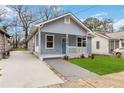 Newly built house with gray siding, blue door, and a paved driveway at 1016 Michigan Nw Ave, Atlanta, GA 30314