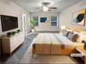 Virtually staged main bedroom with a king-size bed, and neutral decor creating a restful environment at 5120 Lower Elm St, Atlanta, GA 30349