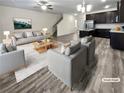 Virtually staged living room with gray sofas, a coffee table, and an open floor plan connecting to the kitchen at 5120 Lower Elm St, Atlanta, GA 30349