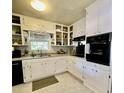 Bright kitchen with white cabinets and new appliances at 684 N Cherokee N Rd, Social Circle, GA 30025