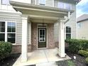Brick front porch with columns and a dark green front door at 2469 Osceola Rd, Lithonia, GA 30058