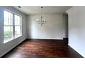 Spacious dining room featuring hardwood floors and a chandelier at 2469 Osceola Rd, Lithonia, GA 30058