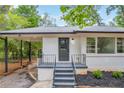 Front entrance with porch and stairs at 5506 Alder Dr, Forest Park, GA 30297