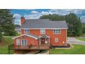 Rear view of brick house with deck and spacious backyard at 2505 Westchester Way, Conyers, GA 30013