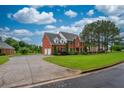 Brick house with a two-car garage and a well-manicured lawn at 2505 Westchester Way, Conyers, GA 30013