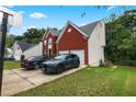 Brick house with a two car garage and driveway at 1812 Beckley Nw Pl, Kennesaw, GA 30152
