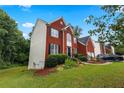Brick house with a side yard and partial view of the house at 1812 Beckley Nw Pl, Kennesaw, GA 30152