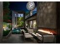 Outdoor patio with fire pit and seating area at night at 748 Charles Allen Dr, Atlanta, GA 30308