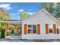 Side view of a white house with wooden accents, showcasing the home's clean lines and modern style at 287 Church St, Dacula, GA 30019