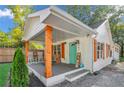 White house with a large front porch, showcasing its stylish design and curb appeal at 287 Church St, Dacula, GA 30019