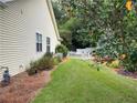 Landscaped side yard with a white picket fence at 781 Azalea Ave, Mcdonough, GA 30253