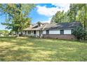 Brick ranch house with a white frame and large yard at 1736 Pleasant Grove Rd, Temple, GA 30179