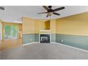 Living room with fireplace, carpet, and ceiling fan at 3127 Fields Dr, Lithonia, GA 30038