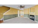 Living room with fireplace, carpet, and ceiling fan at 3127 Fields Dr, Lithonia, GA 30038