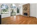 Spacious living room with hardwood floors, stone fireplace and large windows at 7149 Burnside Ct, Villa Rica, GA 30180
