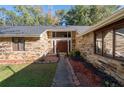 Stone front elevation with a wood door and walkway at 5934 S Deshon Ct, Lithonia, GA 30058