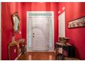 Bright red entryway with hardwood floors and decorative accents at 2797 Club Forest Dr, Conyers, GA 30013