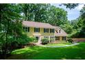 Two-story yellow house with shutters and lush lawn at 4503 Rivercliff Sw Dr, Lilburn, GA 30047