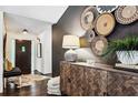 Bright entryway with decorative wall hanging, wooden console table, and cowhide rug at 7350 Ono Rd, Palmetto, GA 30268