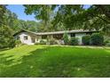 Ranch home with white brick exterior, landscaped lawn, and stone walkway at 7350 Ono Rd, Palmetto, GA 30268