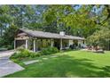 Updated ranch home with a large backyard, detached garage, and lush landscaping at 7350 Ono Rd, Palmetto, GA 30268