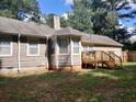 Back of house showing a large deck and a partially visible fenced backyard at 115 Elberta St, Mcdonough, GA 30253
