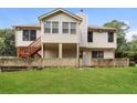 Back of house with a deck and patio at 755 Holcombe Woods Ct, Auburn, GA 30011