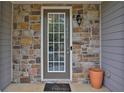 Townhouse front entry with stone accents and a glass door at 5820 Keystone Pt, Lithonia, GA 30058