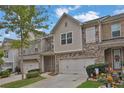 Two-story townhome with two-car garage and landscaping at 5820 Keystone Pt, Lithonia, GA 30058