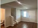 Living room with hardwood floors, neutral walls, and half bathroom at 3271 Forest Green Dr, Douglasville, GA 30135
