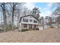 Two-story house with brick and white siding, and a spacious yard with mature trees at 3745 Londonderry Ct, Stonecrest, GA 30038